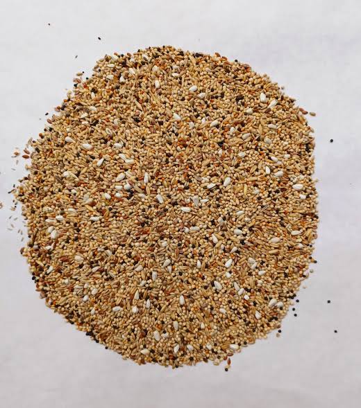 Johnston & Jeff Aviary Mix bird feed in a bag with a colorful label, suitable for various captive birds.