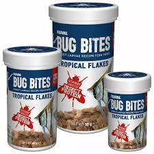 Fluval Bug Bites tropical fish flakes in a clear container, designed for feeding freshwater tropical aquarium fish.