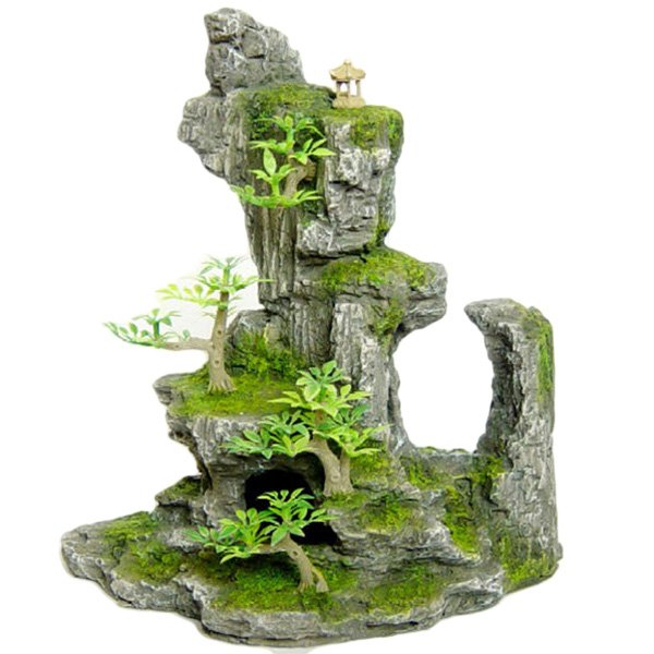Tall Rock Formation With Plant